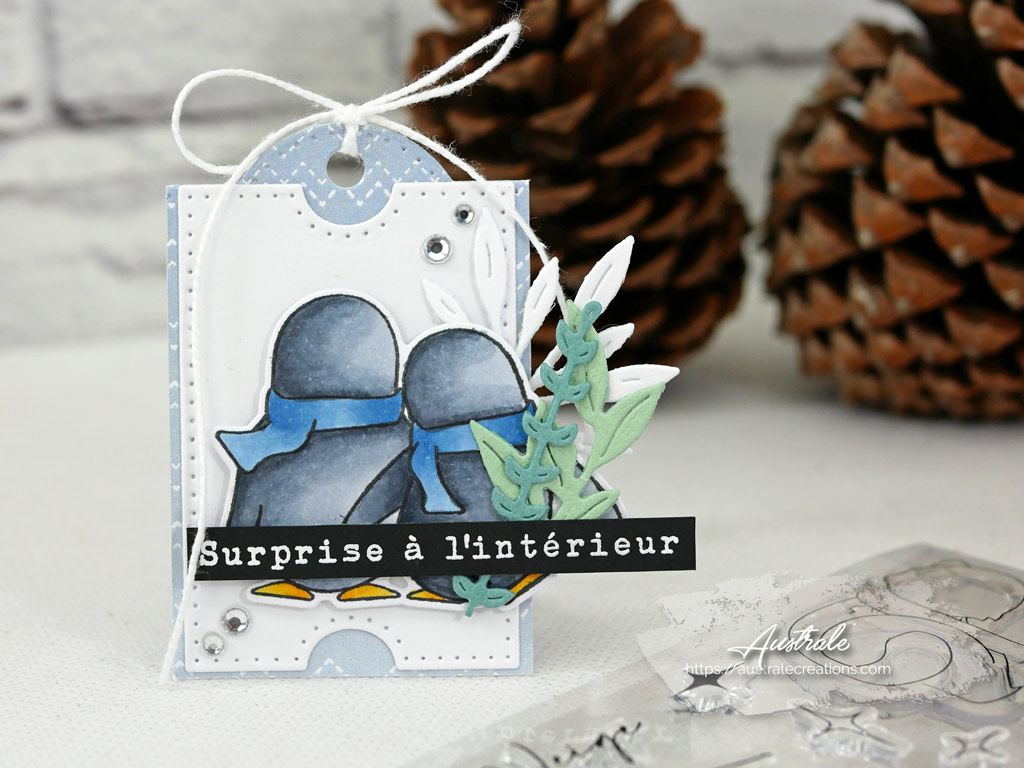 Etiquette cadeau dans un combo en blanc, bleu et verts, pingouins et quelques feuillages.