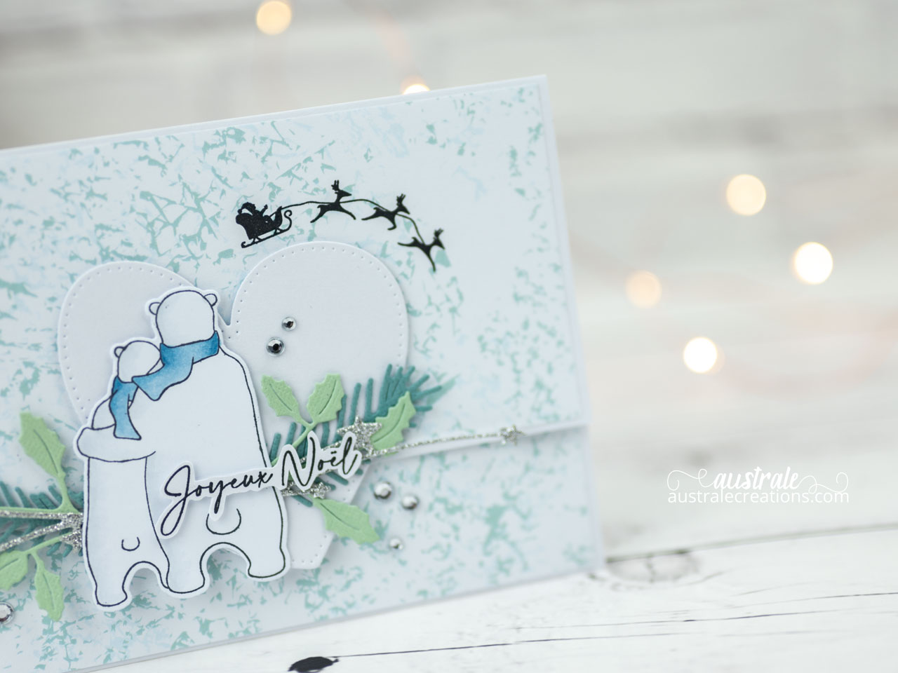 Création d'une pochette cadeau avec rabat aimanté, ours polaire, coeur, traineau volant et feuillages.
